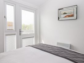 A bedroom with a bed and window at Bonny Bay in Wilsthorpe near Bridlington