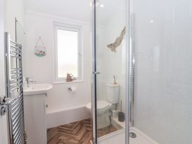 A bathroom with a shower, toilet, and sink at Bonny Bay in Wilsthorpe near Bridlington