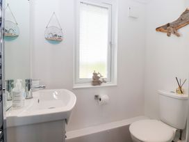 A bathroom with a sink and toilet at Bonny Bay in Wilsthorpe near Bridlington