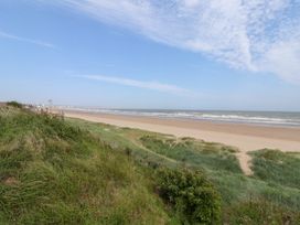 A beach view with dunes and ocean at Bonny Bay in Wilsthorpe near Bridlington