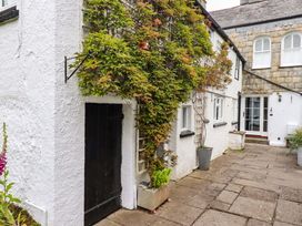 An outdoor area with a door, plants, and a pathway at Clematis House in St Columb Major