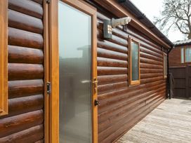 A wooden wall with door and window at Willow in Swanage