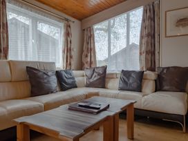 A living room with a sofa and coffee table at Willow in Swanage