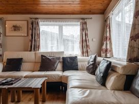A living room with a sofa and coffee table at Willow in Swanage