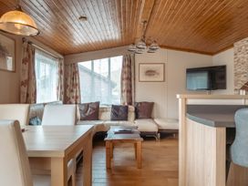 A living room with a sofa and coffee table at Willow in Swanage