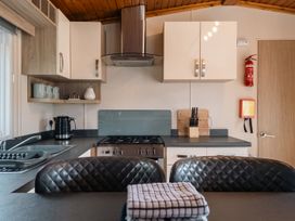 A kitchen with a sink and stove at Willow in Swanage