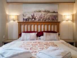 A bedroom with a bed and wall art at Willow in Swanage