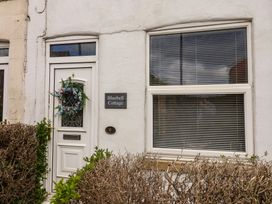 A door and window of Bluebell Cottage in Brayton