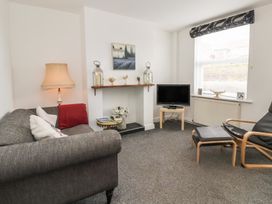 A living room with a sofa and television at Bluebell Cottage in Brayton