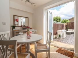 A dining room with a table and chairs at Bluebell Cottage in Brayton