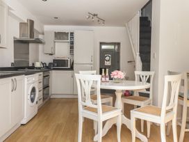 A kitchen with a table and chairs at Bluebell Cottage in Brayton