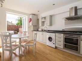 A kitchen with a table and chairs at Bluebell Cottage in Brayton