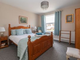 A bedroom with a bed and bedside table at Bluebell Cottage in Brayton