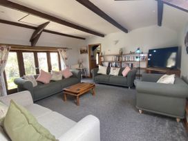 A living room with sofas and a television at Foxglove Barn in South Brent