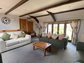 A living room with sofas and a coffee table at Foxglove Barn in South Brent