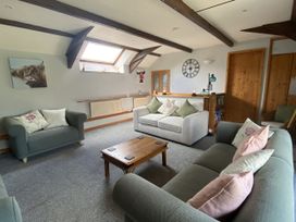A living room with sofas and a coffee table at Foxglove Barn in South Brent