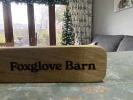 A wooden sign on a table at Foxglove Barn in South Brent