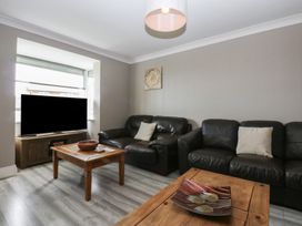 A living room with a television and coffee table at 2 Trem Y Don in Colwyn Bay