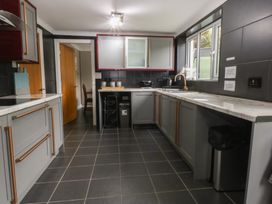 A kitchen with cabinets and appliances at 2 Trem Y Don in Colwyn Bay