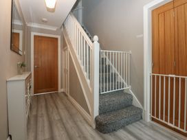 A hallway with stairs and mirror at 2 Trem Y Don in Colwyn Bay