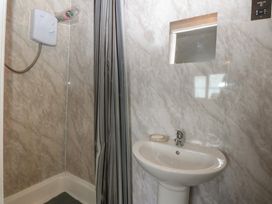 A bathroom with a shower and sink at 2 Trem Y Don Colwyn Bay