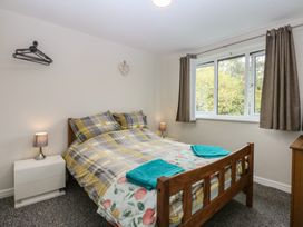 A bedroom with a bed and window at 2 Trem Y Don in Colwyn Bay