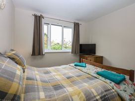 A bedroom with a bed and television at 2 Trem Y Don in Colwyn Bay