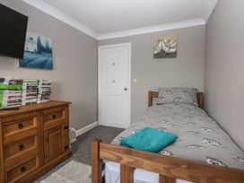 A bedroom with a bed and television at 2 Trem Y Don in Colwyn Bay