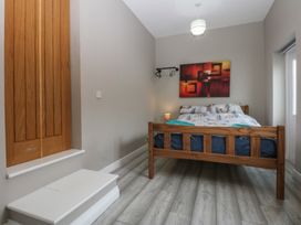 A bedroom with a bed and bedside lamp at 2 Trem Y Don in Colwyn Bay