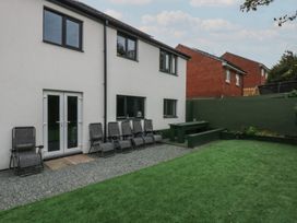 A garden with a house and seating area at 2 Trem Y Don in Colwyn Bay