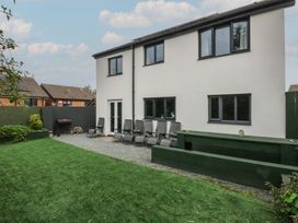 A garden with grass and chairs at 2 Trem Y Don in Colwyn Bay