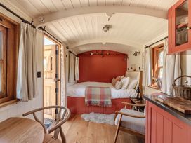 A bedroom with a bed and side table at Spindleberry Hut in Piddletrenthide
