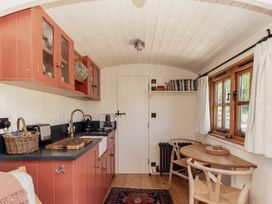 A kitchen with cabinets and a stove at Spindleberry Hut in Piddletrenthide