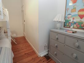 A bedroom with a bunk bed and a dresser at Bodillys Cottage in Newlyn