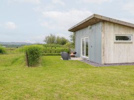 A house with grass and shrubs at The Tinystore in Bodmin