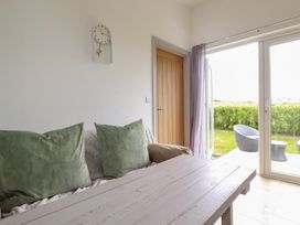 A living room with a sofa and a clock at The Tinystore in Bodmin