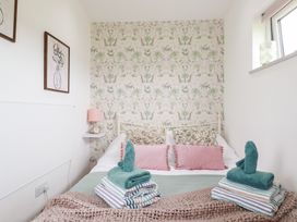 A bedroom with a bed and towels arranged at The Tinystore in Bodmin