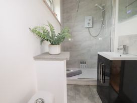 A bathroom featuring a sink, shower, and toilet at The Tinystore in Bodmin