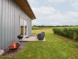 An outdoor area with chairs and a grill at The Tinystore in Bodmin