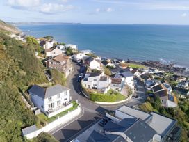 An aerial view of houses and ocean at Looe Island View in Downderry