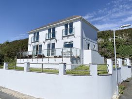 A house with balconies and a garden at Looe Island View in Downderry