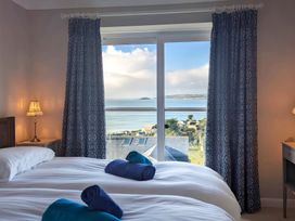 A bedroom with two beds and a view at Looe Island View in Downderry