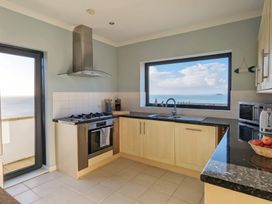 A kitchen with a sink and oven at Looe Island View in Downderry