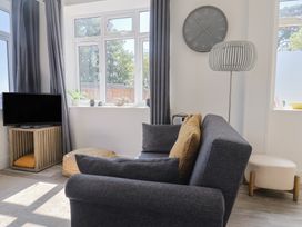 A living room with a sofa and television at Lyme Zest in Lyme Regis
