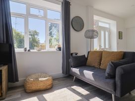 A living room with a sofa and television at Lyme Zest in Lyme Regis
