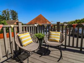 An outdoor seating area with two chairs and a planter at Lyme Zest in Lyme Regis