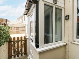 An outdoor area with a gate and windows at Saddlers Cottage in Weymouth