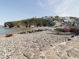 A beach with boats and pebbles at The Waves in Little Haven near Broad Haven
