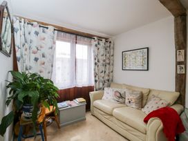 A living room with a sofa and a houseplant at The Old Byre in Woodfalls