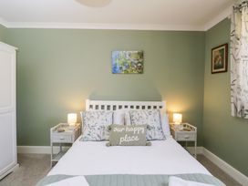 A bedroom with a bed and decorative elements at The Old Byre in Woodfalls